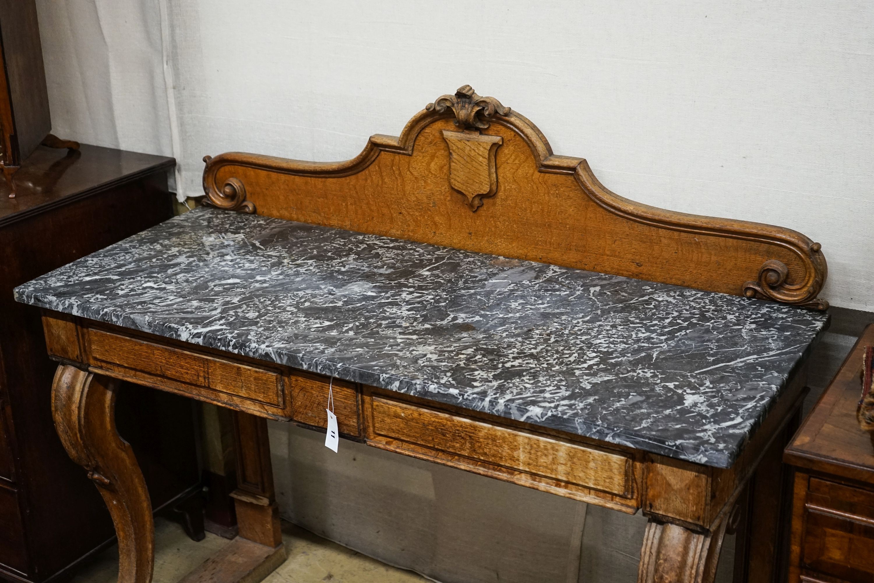 A mid Victorian oak marble topped two drawer console table, width 138cm, depth 54cm, height 120cm